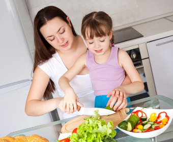 Mother teaches her daughter cooking