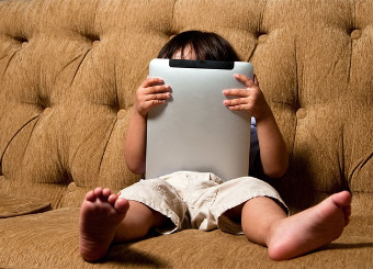 Child holding internet tablet